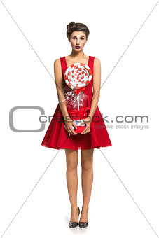 Girl in red dress with big candy