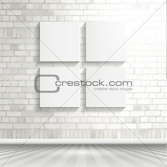 Blank canvases on brick wall 