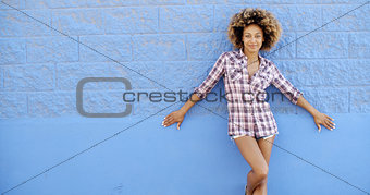 Girl Standing At The Blue Brick Wall