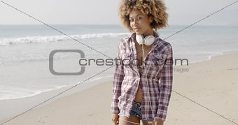 Girl With Headphones Walking On The Beach