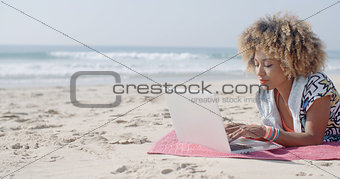 Woman At The Beach Working On A Laptop