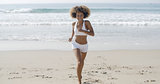 Sporty Woman Running At The Beach