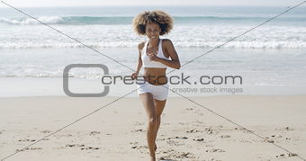 Sporty Woman Running At The Beach
