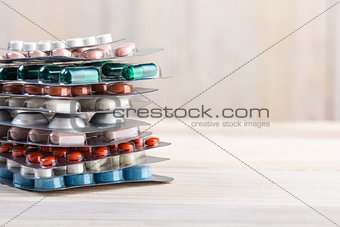 Pills and capsule pile in aluminum containers