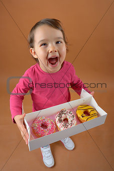 Little girl with different types of donuts