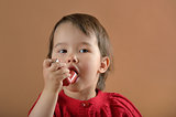 Little girl breathing asthmatic medicine  inhaler