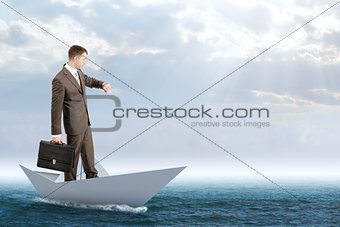 Businessman in paper boat