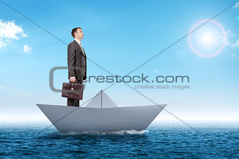 Businessman in paper boat