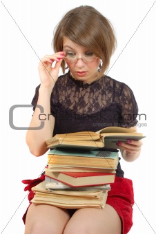 sitting girl look in the book through glasses