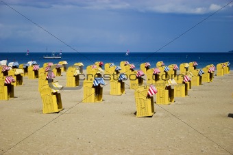 Beach wicker chairs near sea