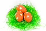 Three red easter eggs with green grass