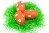 Three red easter eggs with green grass