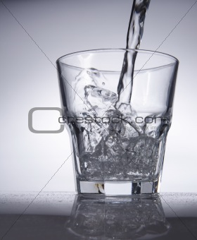 Glass of pouring water