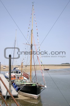 tall boats at low tide