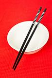 Pair of chopsticks and white bowl