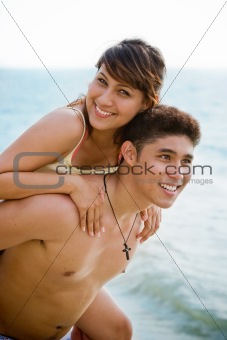 man and woman having fun by the beach