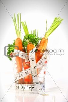 Carrots in a measuring cup with tape measure