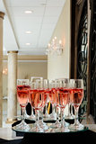 Festive champagne flutes filled with sparkling wine and floating strawberries romantic twinkling party lights
