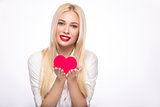 Portrait of Beautiful blond woman with bright makeup and red heart in hand. valentines day
