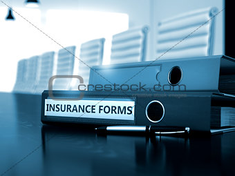 Insurance Forms on Office Binder. Blurred Image.