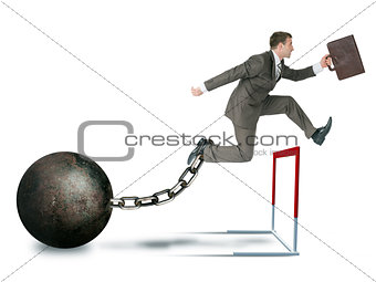 Businessman with irong ball hoppig over barrier