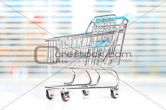 Shopping cart on a white table.