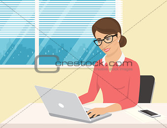 Business woman wearing rose shirt sitting in the office and working with laptop