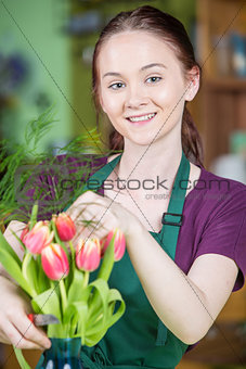 Smiling Female Florist Creating Tulip Arrangement