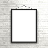 Blank picture frame on brick wall 