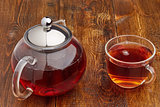 Set of glass teapot and cup black tea