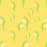 beauty snowdrops on a yellow. seamless vector illustration