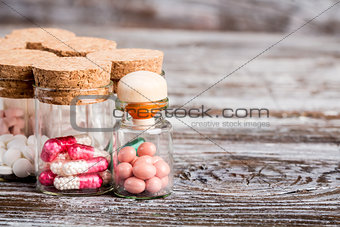 Various medicine in glass containers with cork caps