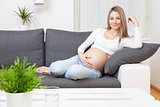 Beautiful pregnant woman relaxing at home