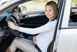 Pregnant woman driving her car