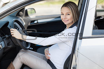 Pregnant woman driving her car