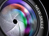 Lens of Digital Camera with Inscription New Skills.