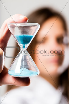 hourglass held by a concerned woman