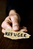 piece of paper with the word refugee