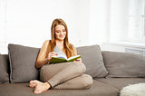 Young Woman Reading a Book at home