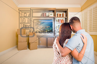 Young Couple Looking At Drawing of Entertainment Unit In Room