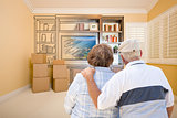 Senior Couple Looking At Drawing of Entertainment Unit In Room