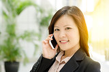 Young Asian businesswoman calling on phone