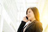Young Asian business woman talking on mobile phone