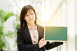 Young Asian business woman showing blank board