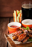Hot chicken wings cooked with honey and soy,  topped with sesame