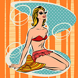 Girl in bikini sitting on beach