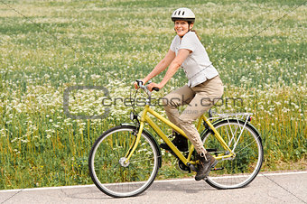 senior woman cycling outdoors