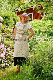 senior woman standing in garden