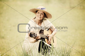 senior woman with guitar outdoors