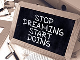 Stop Dreaming, Start Doing - Chalkboard with Hand Drawn Text.